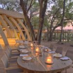 Dinner at Sandibe Safari Camp on wooden deck overlooking Delta