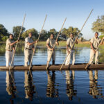 Professional Mokoro guides at Xaranna navigate through the reed lined water channels and lagoons with their guests