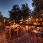 Dinner at dusk by candlelight is an intimate affair at Camp Moremi