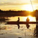 Dusk light highlights Mokoro on water from Chief's Camp