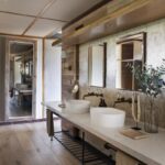 Stylish bathroom interior in a guest room featuring twin basins, natural wood accents, and contemporary design at Chitabe Camp, Botswana
