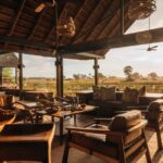 Chitabe Camp Main Area – luxurious thatched lounge, bar, and dining deck offering panoramic views over the Okavango Delta floodplains