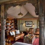 A classically styled library corner with leather seating at Duba Plains