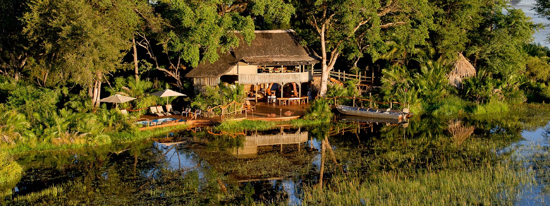 River view of Jacana Camp surrounded by trees