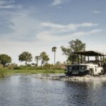 Baine's Camp 4x4 safari vehicle crosses water in the Delta