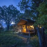 Guest tent exterior at night time at Sango Safari Lodge