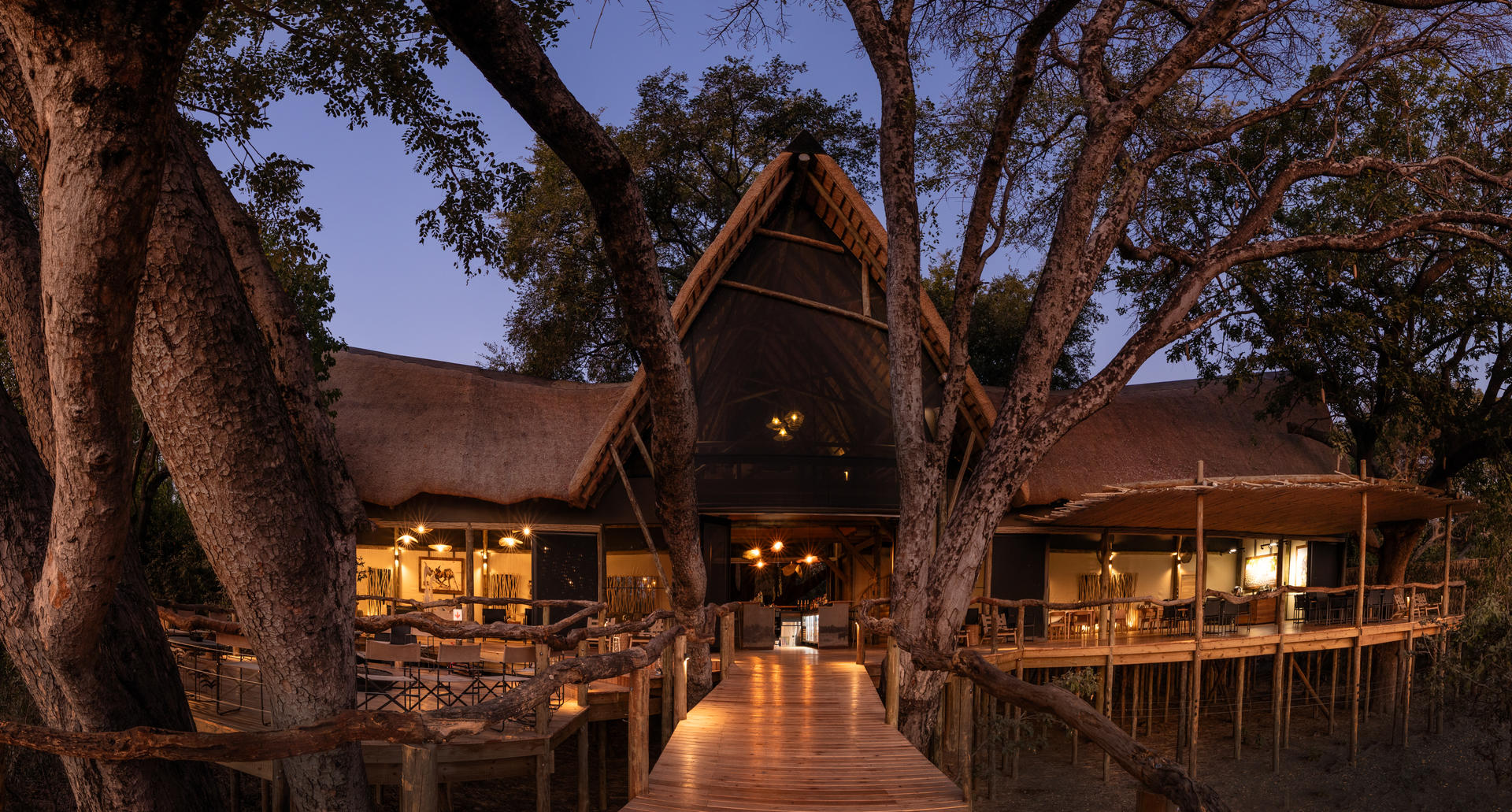 Tubu Tree camp lit up at night in the Okavango Delta