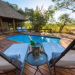 Deck chairs and champagne by a private pool at Splash Camp.