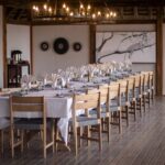 Spacious bedroom with a king-sized bed and wooden deck views at Splash Camp.