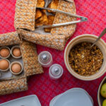 Bush breakfast spread with eggs, fruit, and pastries at Kwara Camp.