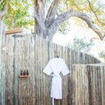 Safari-style bathroom with clawfoot tub and wooden counters at Kwara Camp.