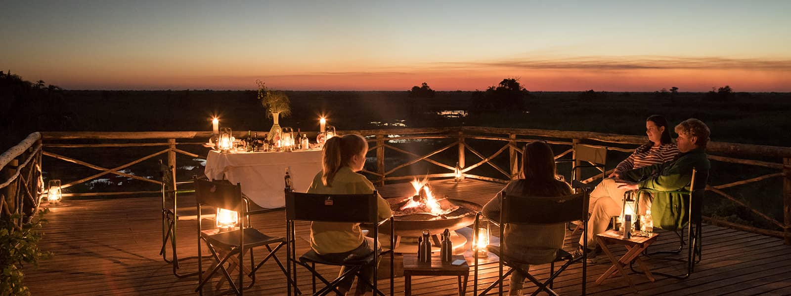 Sundowner drinks being enjoyed around Setari's camp fire