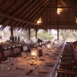 Thatched communal dining room table at Camp Kalahari