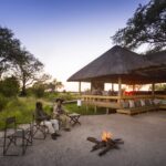 Little Sable Camp guests relax in the sunken lounge with fire pit