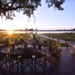 Sunset drinks on the wooden deck at Mapula Lodge