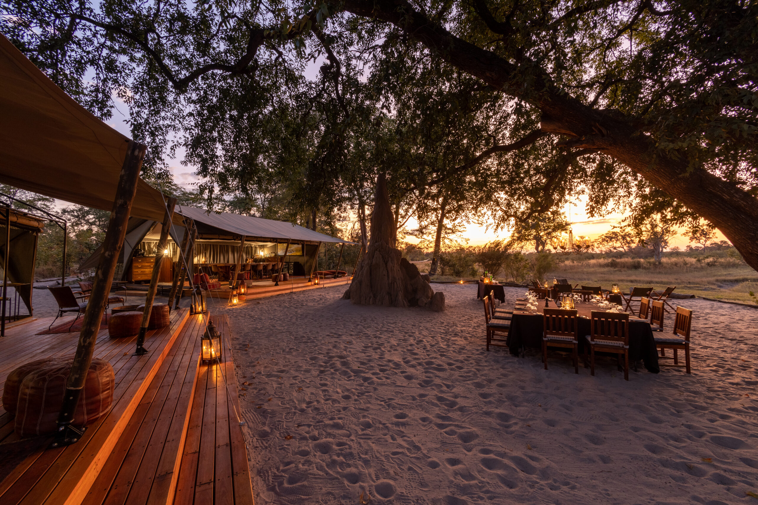 Main lounge and outdoor dining area at Selinda Explorers Camp during sunset in Botswana safari.