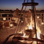 Belmond Safaris, Savute Elephant Lodge - guests enjoying the fire place