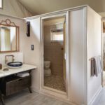 En suite bathrooms are luxuriously appointed with outside showers at Savute