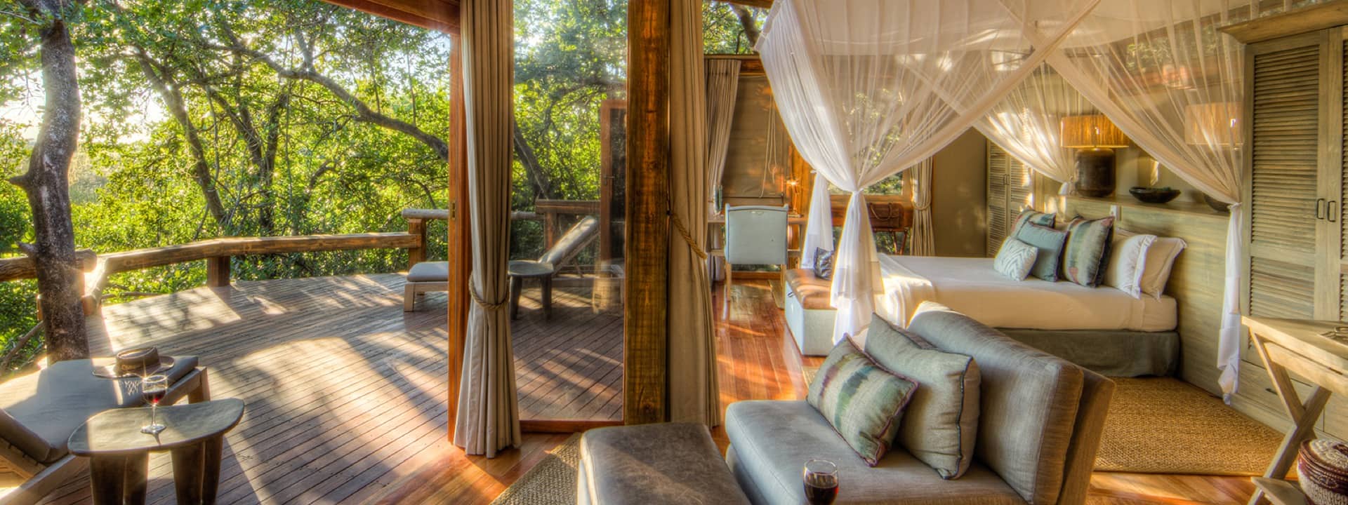 Interior bedroom and lounge space of Camp Okavango guest tent