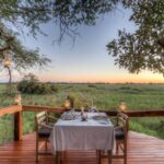 Private dinner for two set up on viewing deck at Camp Okavango