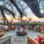 The attractive fire pit deck and seating at Camp Xakanaka