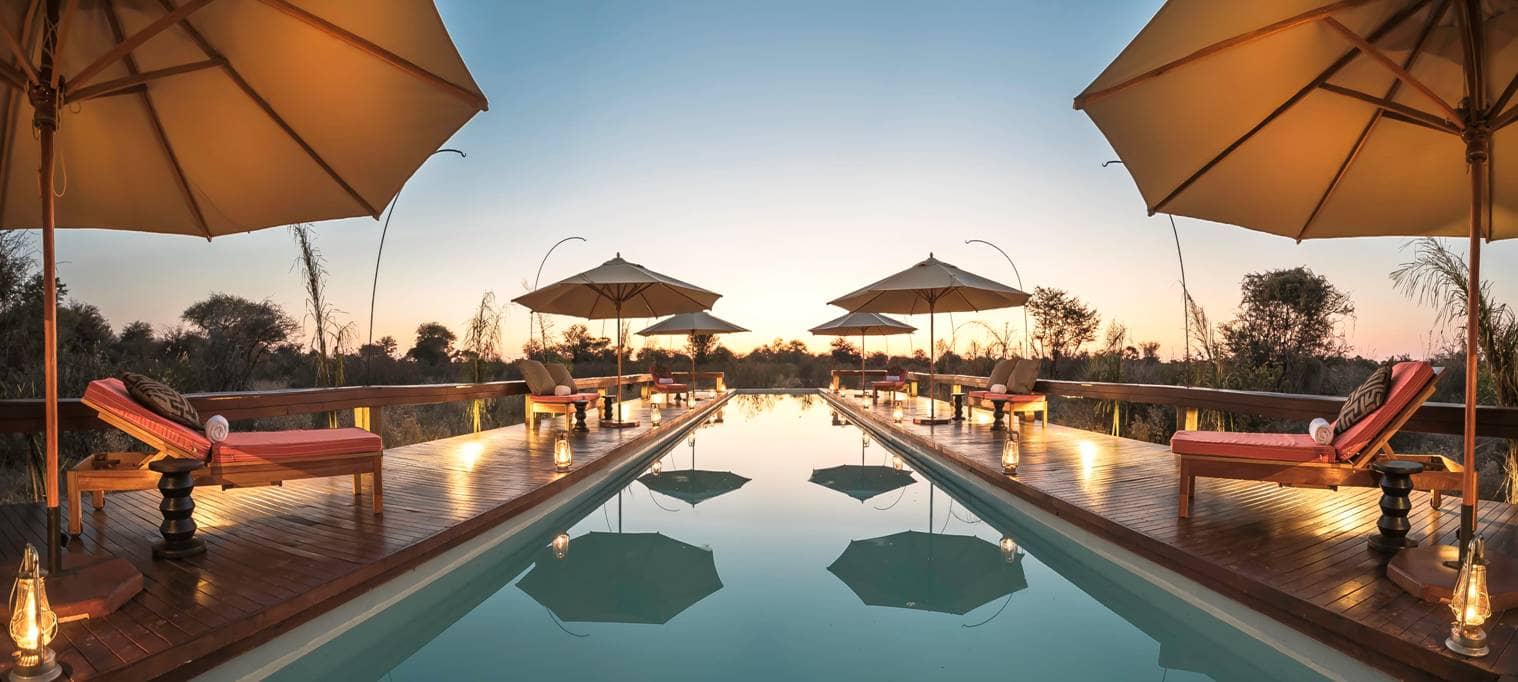 Late afternoon umbrella shadows over the pool at Feline Fields Lodge