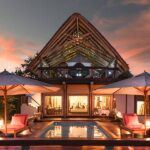 Sunset view of the graceful Feline Field Lodge and pool