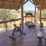The thatched fully equipped gym facility at Feline Fields Lodge