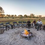 Guests enjoy the open space seated around Gomoti's fire pit
