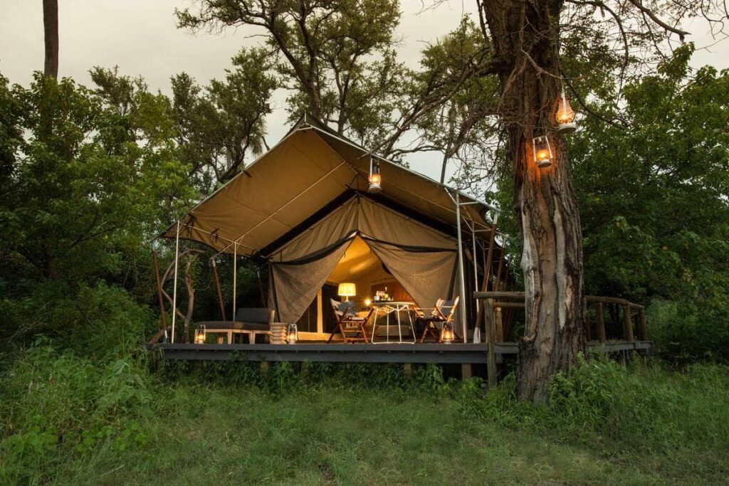 Exterior view of Gomoti Plains Tent by lantern ligh