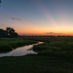 Sunset over Linyanti floodplains with river and grassy landscape in Botswana.