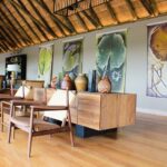 Spacious and elegantly furnished lounge area at Kanana Camp, featuring plush seating and expansive views of the Okavango Delta.