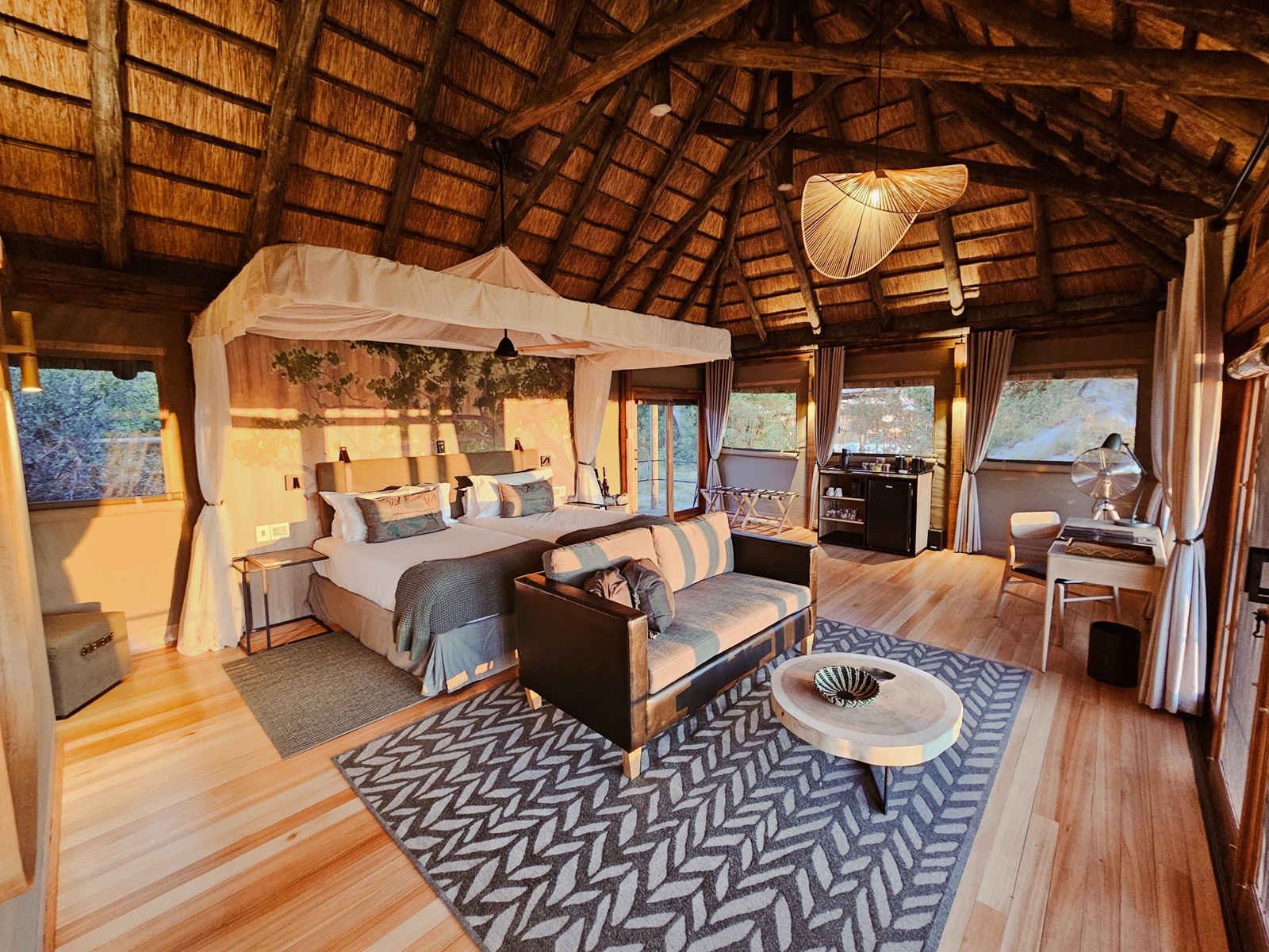 Interior of a luxury tented suite at Kanana Camp in the Okavango Delta, featuring elegant furnishings and expansive views of the surrounding delta landscape,