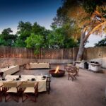 Linyanti Leadwood boma with fire pit and outdoor dining tables in Botswana.