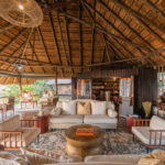 Open-air safari lounge with comfortable seating and thatched roof at Lebala Camp.