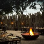 A Mombo traditional boma dinner awaits guests returning from safari