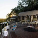The dining area and fire deck at Okuti Camp offer sweeping views of the Okavango