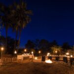 Boma dinner with fire under night sky at Pelo Camp