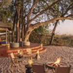 The main area at Shinde Footsteps Camp combines the dining room, lounge and fire pit overlooking the Okavango waters