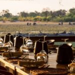 Dining room table with animals in background at Savuti Camp