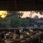 The dining area at Savuti Camp with a sunset view