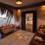 The African themed ensuite bathroom with copper bath at Selinda