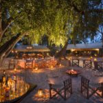 Lantern lit dinner location and outside bar at Selinda Explorers Camp