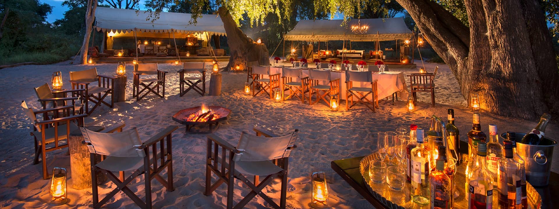 Lantern lit dinner location and outside bar at Selinda Explorers Camp