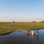 A scenic helicopter flight lands at the start of a mokoro excursion