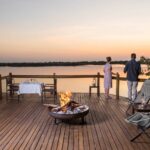 Wooden viewing deck at Xugana camp with campfire