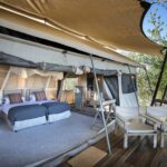 Linyanti Expeditions tent exterior with open deck and seating in Botswana.