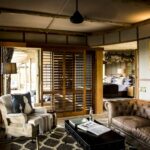 Spacious lounge area within guest room at Little Mombo