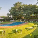 The lush gardens surrounding the pool area at Batonka