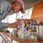 Camp staff preparing gin and tonics and refreshments at Okavango Horse Safaris Fly Camp.